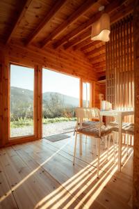 a wooden room with a table and a chair at Deux Chalets face à la vallée in Chalezeule