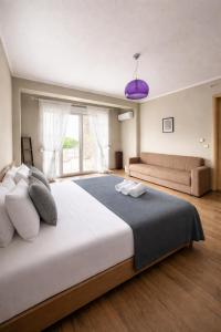 a large bedroom with a large bed and a couch at Sunrise Villa in Kassandra