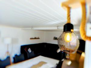 a lamp hanging from the ceiling in a living room at Ferienhaus am Erzgebirgskamm in Marienberg