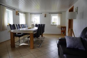 a dining room with a table and chairs at Ferienhaus am Erzgebirgskamm in Marienberg