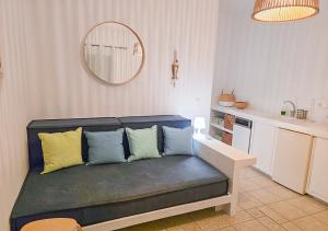 a couch with pillows on it in a living room at Panostria Apartments Sifnos in Sifnos
