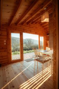 a wooden cabin with a desk and a chair at Deux Chalets face à la vallée in Chalezeule +82 photos
