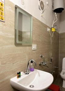 a bathroom with a sink and a mirror and a toilet at The Boho Darjeeling in Darjeeling
