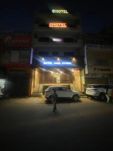 a person standing in front of a hotel at night at hotel shree krishna vaishnav in Agra