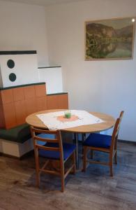 a table and chairs in a room with a painting at Tremlhof in Unterach am Attersee