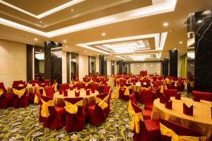 a banquet hall with red and yellow tables and chairs at Sahid Batam Center Hotel and Convention in Batam Center