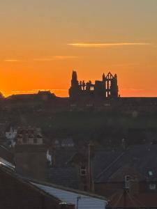 a silhouette of a castle at sunset at Norman Guest House with Free Parking in Whitby