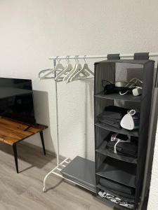 a room with a tv and a shelf with shoes at Monteurswohnung Hamm in Hamm