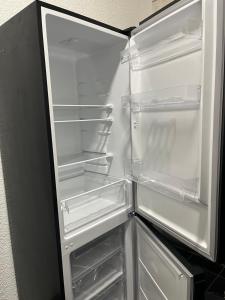 an empty refrigerator with its door open in a kitchen at Monteurswohnung Hamm in Hamm