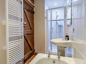 a bathroom with a tub and a sink and a shower at 3 Bed in Winkleigh oc-1450b in Iddesleigh +19 photos