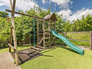 a playground with a slide and a swing set at 3 Bed in Winkleigh oc-1450b in Iddesleigh