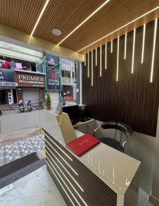 a lobby with a desk with a red book on it at Hotel Magic Inn in Nagpur