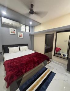 a bedroom with a large bed and a mirror at Hotel Magic Inn in Nagpur