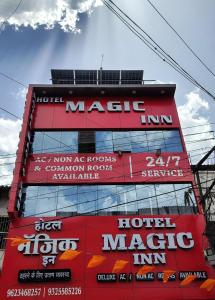 a red building with signs on the side of it at Hotel Magic Inn in Nagpur