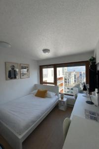 a bedroom with a white bed and a large window at Apparteo Strasbourg in Strasbourg +18 photos
