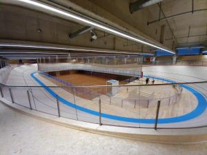 a basketball court in a building with a basketball hoop at Ostello Sport Center in Monte Ceneri