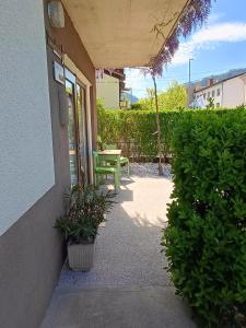 a patio with a green bench and a table at Gravitacija East in Tolmin