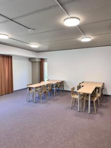 a conference room with tables and chairs in it at Ostello Sport Center in Monte Ceneri +61 photos