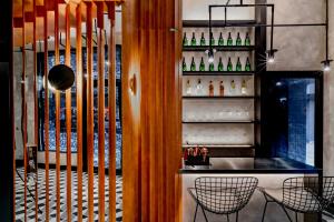 a restaurant with a bar with bottles on the wall at Oootopia West in Hong Kong