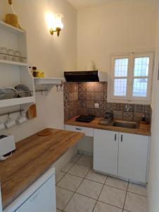 a kitchen with white cabinets and a wooden counter top at San Giorgio in Gaios