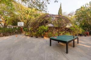 a ping pong table in a parking lot at StayVista at Ananta - Breakfast Included & Basketball Court in Bangalore