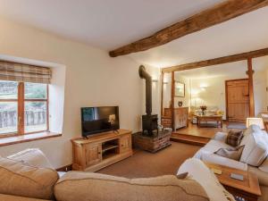 a living room with a couch and a tv at 3 Bed in Barnstaple oc-60511 in Swimbridge