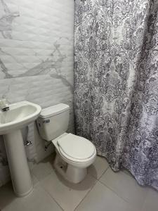 a bathroom with a toilet and a sink at Brise Dorée de Punta Rucia in Punta Rucia