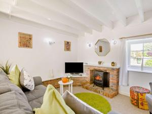 a living room with a couch and a fireplace at 2 Bed in Bideford oc-60428 in Westward Ho