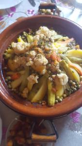 a bowl of food with peas and vegetables at Chez houssam in Ouarzazate