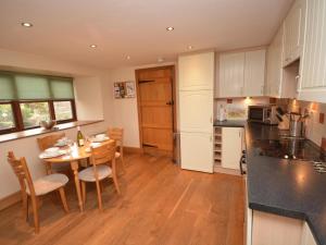 a kitchen and dining room with a table and chairs at 2 Bed in Minehead oc-41218 in Timberscombe
