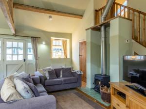 a living room with a couch and a stove at 2 Bed in Axminster oc-bloom in Axminster