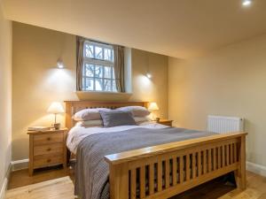 a bedroom with a large bed and a window at 2 Bed in Axminster oc-bloom in Axminster