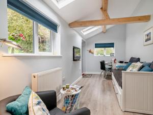 a living room with a couch and a table at 1 Bed in Bridport oc-94617 in Chideock