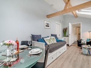 a living room with a couch and a table at 1 Bed in Bridport oc-94617 in Chideock