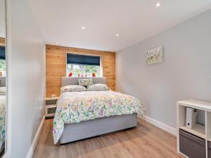 a white bedroom with a bed and a window at 1 Bed in Bridport oc-94617 in Chideock