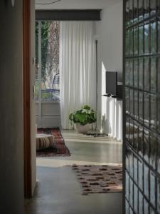 a hallway with a door open to a room with a plant at ArtBau Designhotel in Waldkirch
