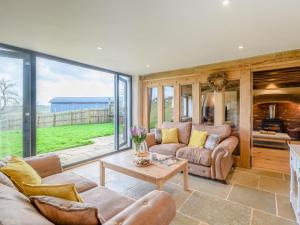 a living room with a couch and a table at 5 Bed in Tiverton oc-48151 in Cadeleigh