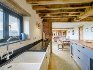 a kitchen with wooden ceilings and a large sink at 5 Bed in Tiverton oc-48151 in Cadeleigh +56 photos