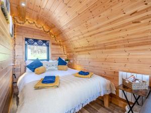 a bedroom with a bed in a log cabin at 1 Bed in Barnstaple oc-90190 in Bratton Fleming