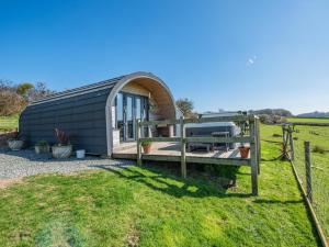 a tiny house with a deck and a fence at 1 Bed in Barnstaple oc-90190 in Bratton Fleming