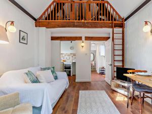 a living room with a white couch and a loft at 1 Bed in Minehead oc-90923 in Minehead
