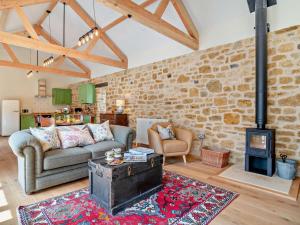 a living room with a couch and a wood stove at 2 Bed in Stoke Abbott oc-94406 in Stoke Abbott