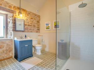 a bathroom with a toilet and a sink and a shower at 2 Bed in Stoke Abbott oc-94406 in Stoke Abbott