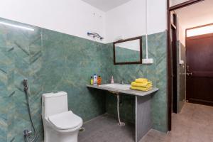 a bathroom with a toilet and a sink and a mirror at Kalyan Villa Heritage Stay in Udaipur +34 photos