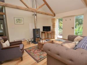 a living room with two couches and a fireplace at 2 Bed in Stoke Abbott oc-50884 in Stoke Abbott