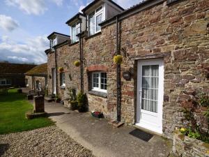 an old brick house with a white door at 2 Bed in Bideford oc-60430 in Westward Ho