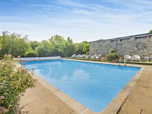 a swimming pool in front of a brick building at 2 Bed in Bideford oc-60430 in Westward Ho