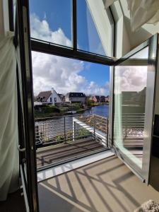 a balcony with a view of the water at Waterfront in Alkmaar