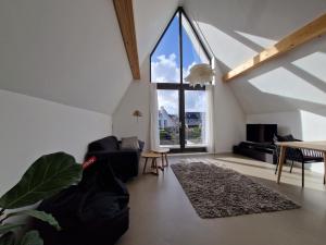 a living room with a large window and a couch at Waterfront in Alkmaar