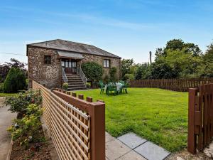 a house with a fence and a grass yard at 3 Bed in Holsworthy oc-tcsheph in Merryfield